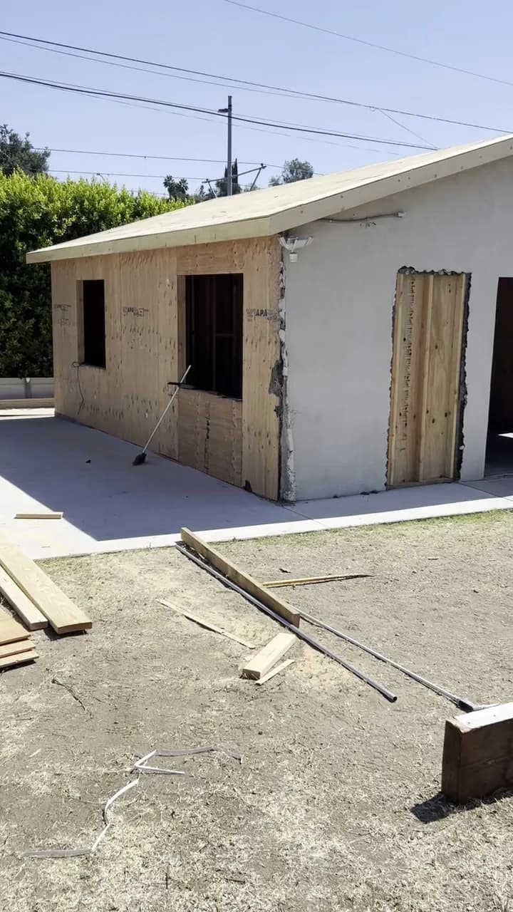 Detached garage being converted into an ADU with new framed walls and window openings