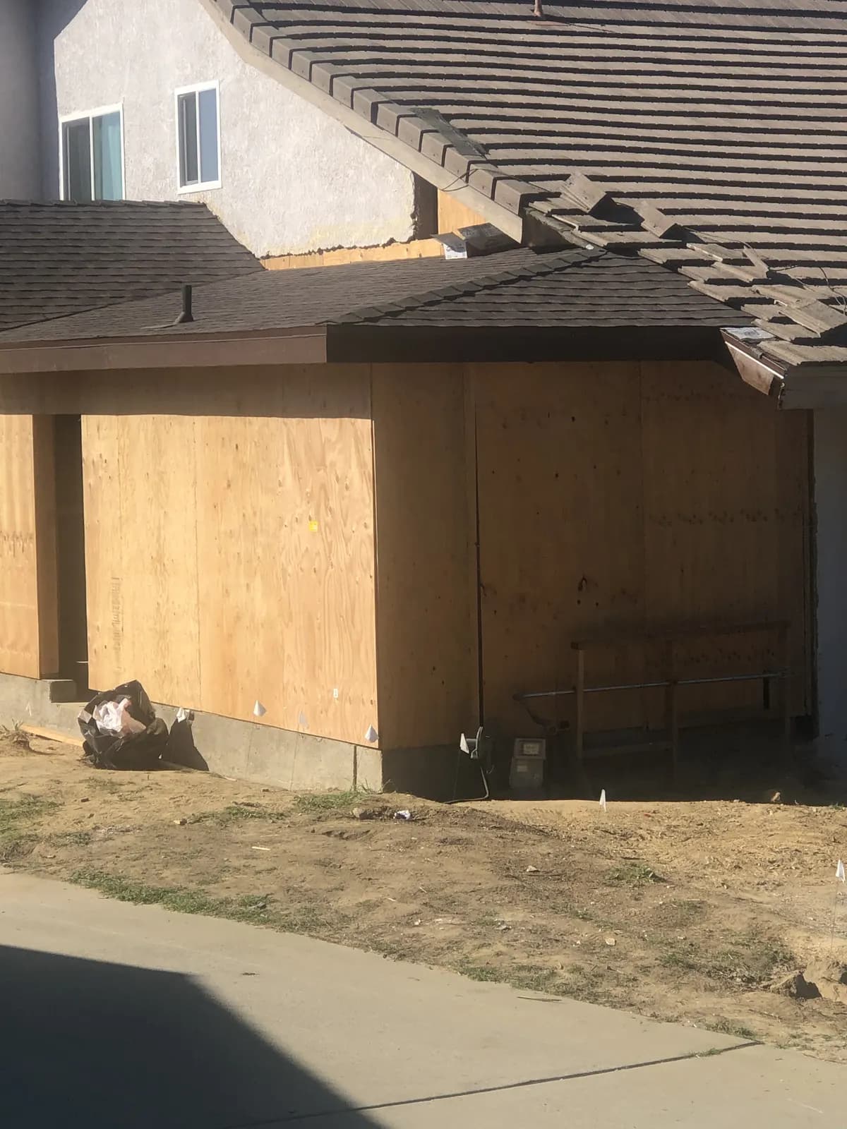 Single-story addition with plywood shear wall sheathing and new shingle roof