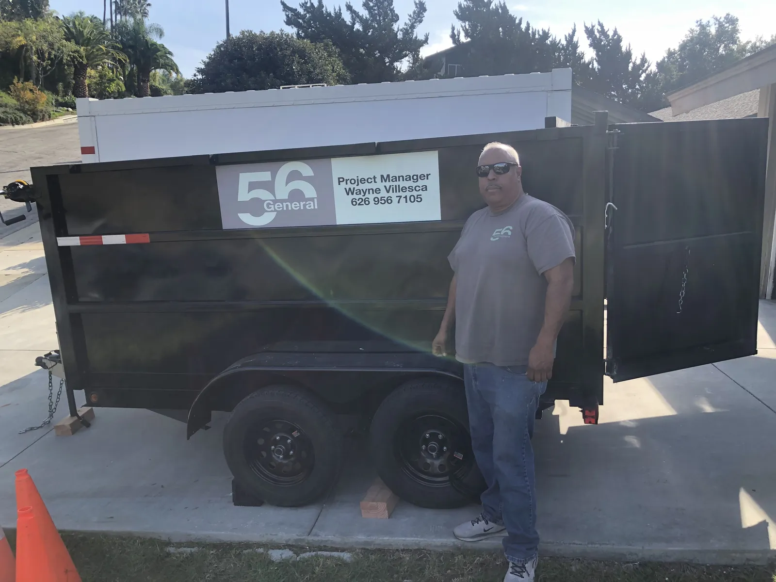 Wayne Villesca, Project Manager, standing next to the 56 General dump trailer
